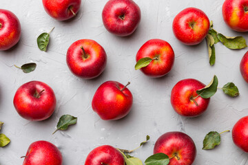 Many red apples on colored background, top view. Autumn pattern with fresh apple above view