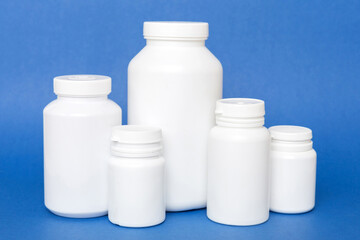 supplement pills with medicine bottle health care and medical top view. Vitamin tablets. Top view mockup bottle for pills and vitamins with green leaves, natural organic bio supplement, copy space