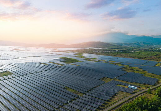 Aerial top view Solar panels installed in green field. Concept alternative clean energy generator for environment
