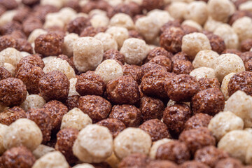 Chocolate dry breakfast cereal as a texture, side view. Selective focus
