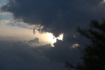 Sunset Through Clouds Over A Mountain Range