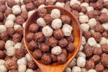 Wooden spoon and dry cereal breakfast, close-up, top view