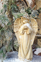 Sculpture of a Beautiful Angel in Snowy Garden