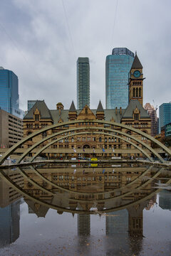 Nathan Phillips Square pond reflecting Old City Hall in Toronto