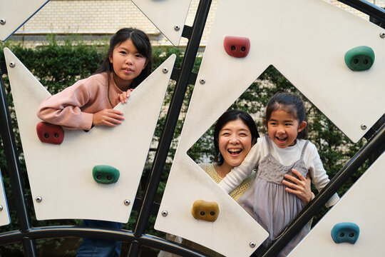 Japanese family enjoying playtime at a playground