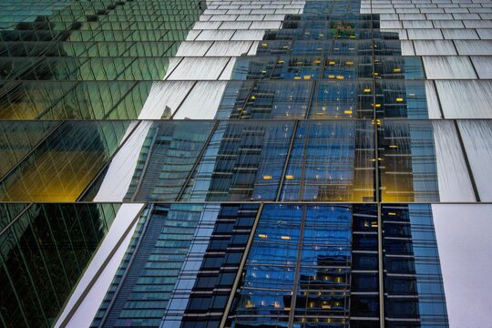 Glass facade reflecting modern architecture and business building