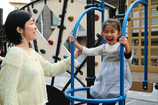 Japanese mother and daughter enjoying active playground fun