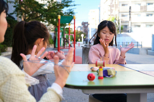 Japanese girls playing cat's cradle string game
