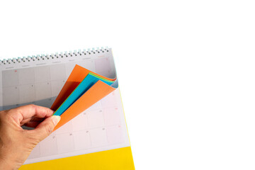 Hand Turning Colorful Pages Of Calendar. Isolated on transparent background.