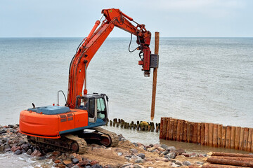 A machine for driving wooden breakwaters on the seashore