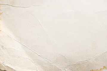 A sheet of rough beige wrinkled paper texture as background