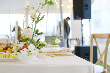 Elegant table setting with floral centerpiece and gourmet food display, creating a sophisticated atmosphere for a special event or celebration with inviting ambiance