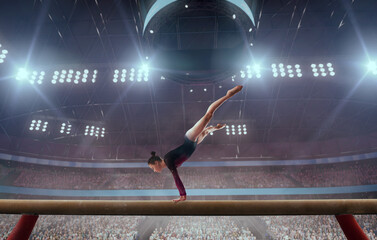 A gymnast performs a difficult trick on a balance beam.