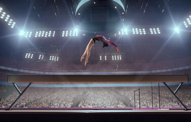 A gymnast performs a difficult trick on a balance beam.