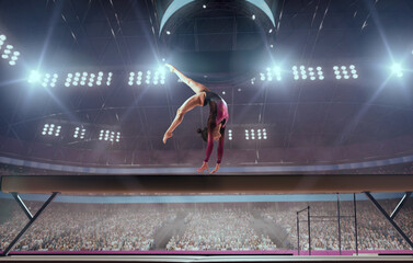 A gymnast performs a difficult trick on a balance beam.