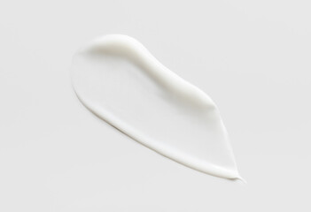 cosmetic smear of creamy texture on gray background