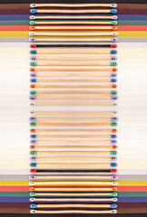 Multicolored matchsticks with faces painted on the heads on multicolored paper