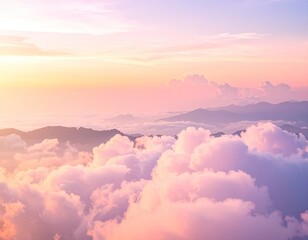 Majestic pastel sunset view above a sea of clouds and distant mountains.
