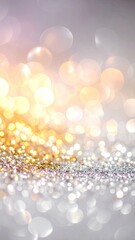 Abstract background featuring shimmering gold and silver glitter with soft bokeh lights.
