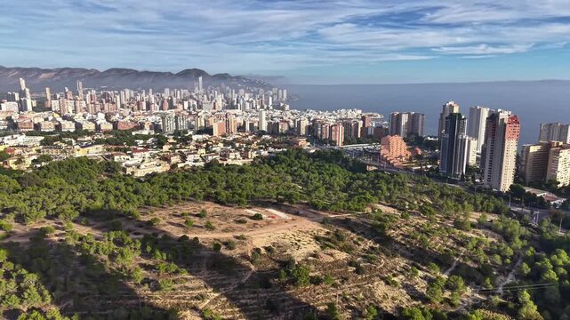 Aerial Vacant Urban Lot Surrounded By Greenbelt And Distant Coastline Ideal For Development Planning,