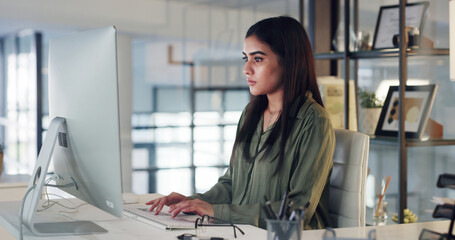 Online, research and woman with computer, office and email marketing on web, serious and copywriting. Typing, project and person with info for article, copywriter and creative with technology or app