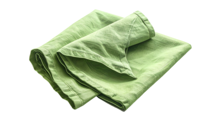 A close-up shot of a neatly folded, light-green cloth napkin isolated on a stark black background, showcasing its texture