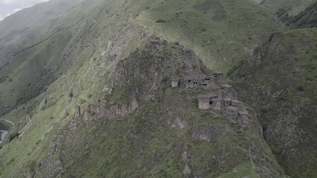 Stunning scenery of the ancient stone mountain village of Mutso in the Khevsureti region of Georgia, featuring dramatic architecture set within a rugged alpine landscape