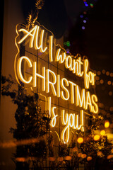 Warm glowing neon Christmas sign with festive bokeh lights