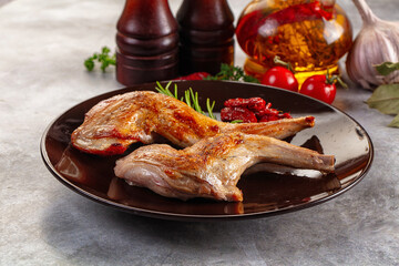 Roasted rabbit leg served rosemary