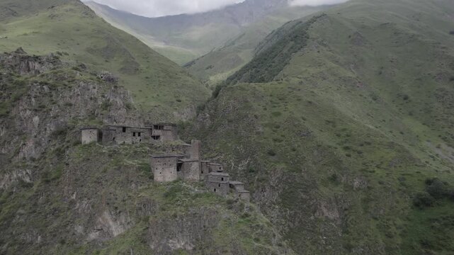 Stunning scenery of the ancient stone mountain village of Mutso in the Khevsureti region of Georgia, featuring dramatic architecture set within a rugged alpine landscape