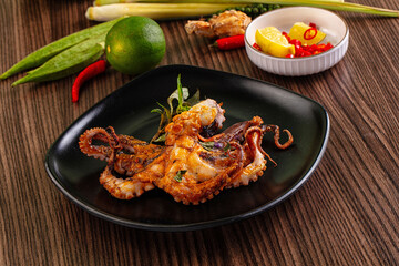 Gourmet grilled whole octopus served lime