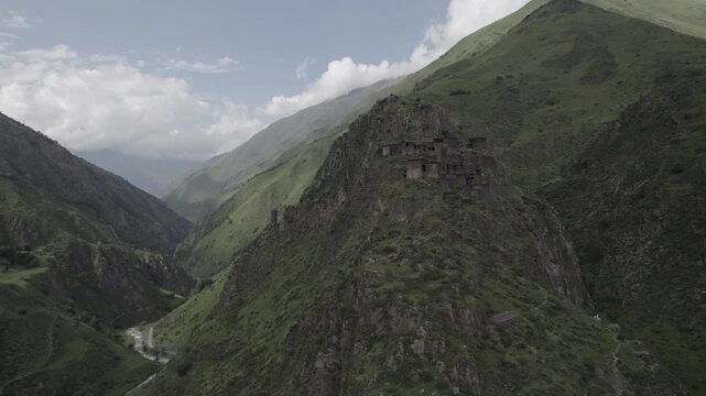 Stunning scenery of the ancient stone mountain village of Mutso in the Khevsureti region of Georgia, featuring dramatic architecture set within a rugged alpine landscape