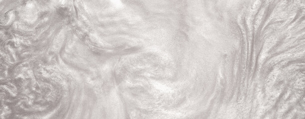 Shimmering silver abstract background. Liquid glitter paint texture waves and swirls. Beautiful shiny white glitter texture. Metallic silver paint close-up as a holiday background.