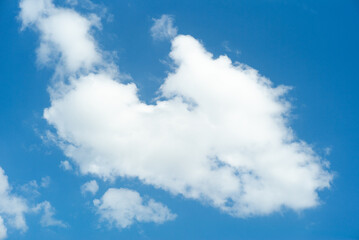 The white fluffy cloud floating in the clear blue sky