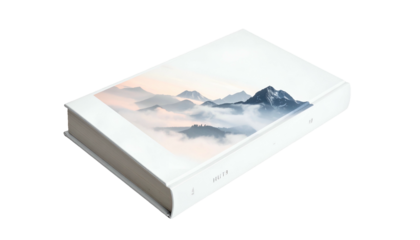 A hardcover book with a landscape scene on the cover, featuring mountains and mist, set against a pastel sky