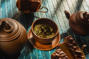 Still life with a piece of cake and morning tea - a delicious breakfast on a dark background