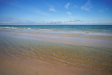 Beautiful sandy beach. Crystal-clear water. Baltic Sea. Sunny summer day. Poland.