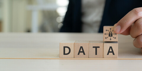 Data protection and digital security concept. Wooden blocks with text DATA and padlock icon. Data protection, privacy, cybersecurity, secure networks, encryption and safeguarding information.