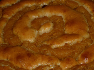 Homemade sweet pastry spiral with fruit filling close-up