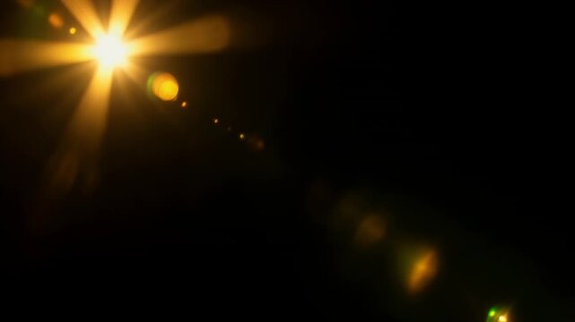 Glowing core emitting starburst as camera shifting, sending diagonal ghosts on black, copy space