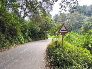 Indian road cautionary sign indicating speed breaker ahead. Sign indicating to slowdown as speed bump in road