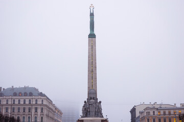The Freedom Monument (Brīvības piemineklis), one of Latvia&rsquo;s most important national landmarks, photographed in Riga during a foggy winter day. The monument symbolizes independence, freedom, and natio
