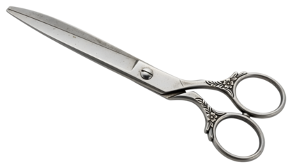 Vintage silver scissors with floral engraved handles isolated on a transparent background