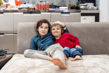 Two brothers relaxing on sofa at home
