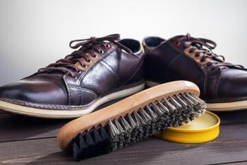 Shoe care accessories on a wooden table. Close-up.