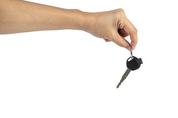 A black motorcycle key in a hand against a transparent background.