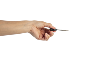 A black motorcycle key in a hand against a transparent background.