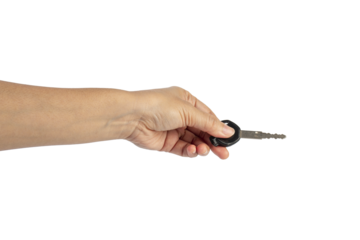 A black motorcycle key in a hand against a transparent background.