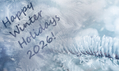 spruce branch in the snow through a frosty window with text Happy Winter Holidays.