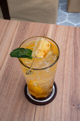 Exotic Refreshment: A refreshing beverage, adorned with a slice of pineapple and a sprig of mint, invites a moment of pure refreshment, the perfect treat.